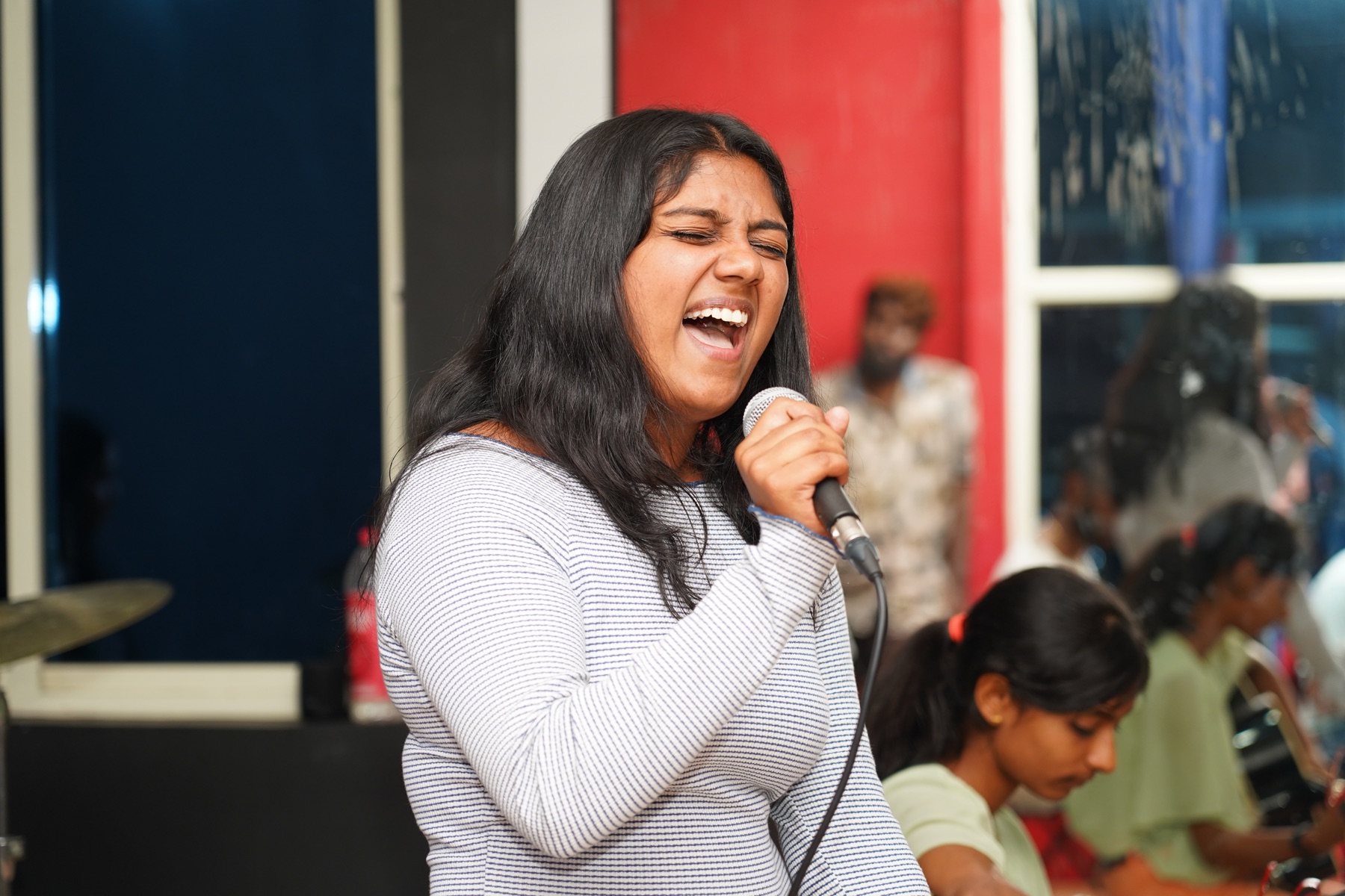 SARA Music School western vocals student singing confidently with a microphone